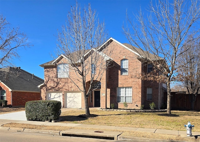 traditional-style house with brick siding, fence, a garage, driveway, and a front lawn