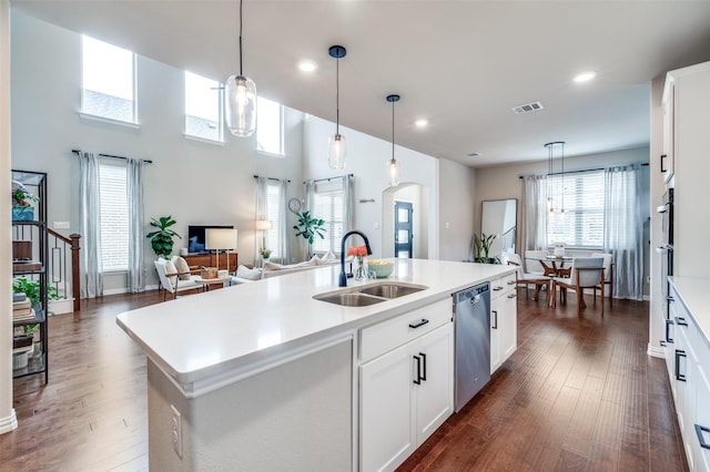 2064 Olivereta Dr, Little Elm, TX 75068 - kitchen featuring a sink, arched walkways, stainless steel dishwasher, a center island with sink, and light countertops
