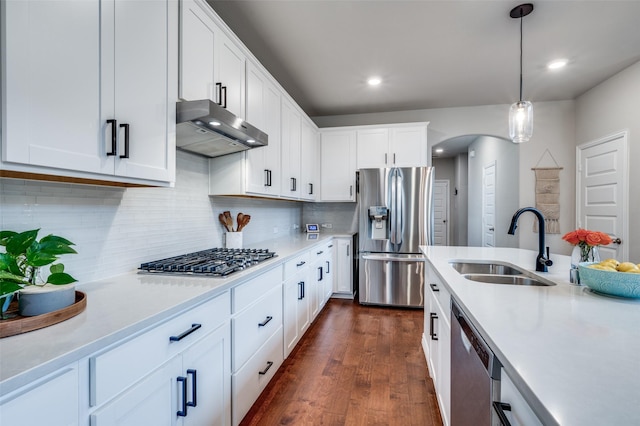 2064 Olivereta Dr, Little Elm, TX 75068 - kitchen featuring stainless steel appliances, range hood, a sink, light countertops, and dark wood-type flooring
