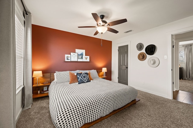 bedroom featuring carpet floors, visible vents, baseboards, and a ceiling fan