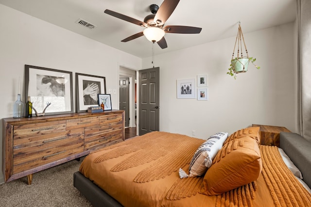 carpeted bedroom with a ceiling fan and visible vents