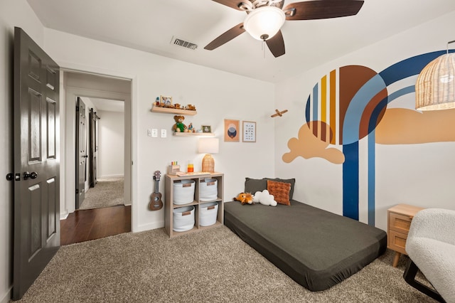 living area with ceiling fan, visible vents, and carpet flooring