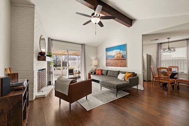 living area featuring vaulted ceiling with beams, dark wood-style floors, a fireplace, and a ceiling fan