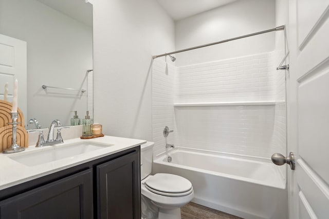 bathroom with toilet, tub / shower combination, wood finished floors, and vanity