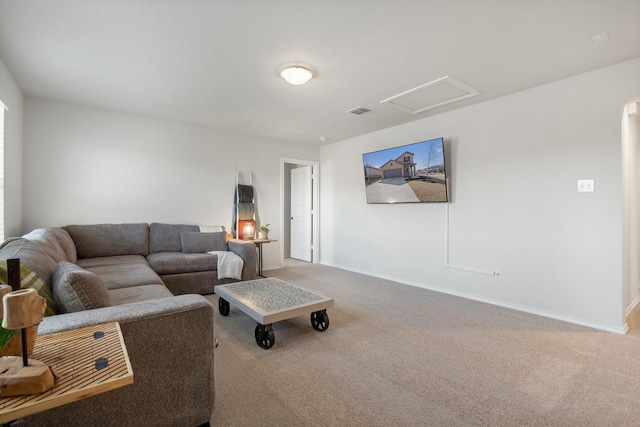 carpeted living area with attic access, visible vents, and baseboards