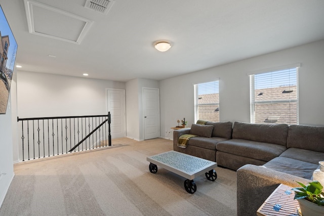 carpeted living area featuring attic access, recessed lighting, and visible vents