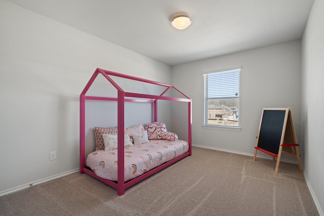 carpeted bedroom featuring baseboards