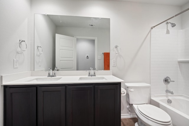 full bathroom featuring visible vents, a sink, toilet, and double vanity