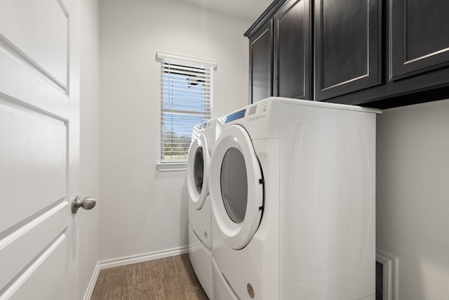 laundry area featuring wood finished floors, cabinet space, baseboards, and separate washer and dryer