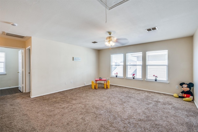 recreation room featuring attic access, visible vents, plenty of natural light, and carpet floors