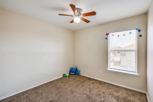 empty room featuring carpet floors, a ceiling fan, and baseboards