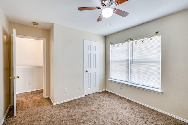 unfurnished bedroom with ceiling fan, a closet, carpet flooring, and baseboards