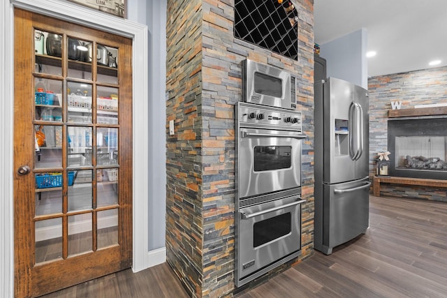 kitchen with appliances with stainless steel finishes, dark wood finished floors, and recessed lighting