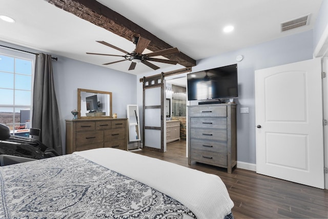 bedroom featuring a barn door, visible vents, baseboards, dark wood-style floors, and beamed ceiling