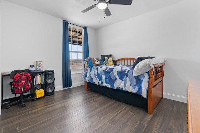 bedroom with ceiling fan, baseboards, and wood finished floors