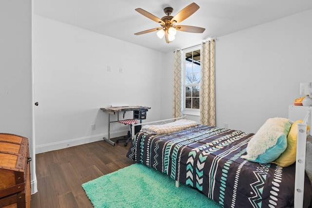 bedroom featuring a ceiling fan, baseboards, and wood finished floors