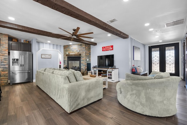 living room featuring dark wood-style flooring, visible vents, beamed ceiling, and french doors