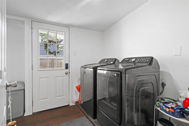 clothes washing area featuring dark wood-type flooring, laundry area, and independent washer and dryer