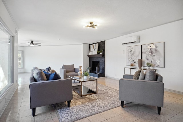 living room with baseboards, an AC wall unit, a fireplace, and tile patterned floors