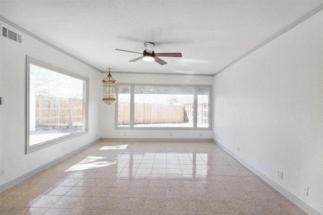 empty room featuring a wealth of natural light, visible vents, baseboards, and ceiling fan with notable chandelier