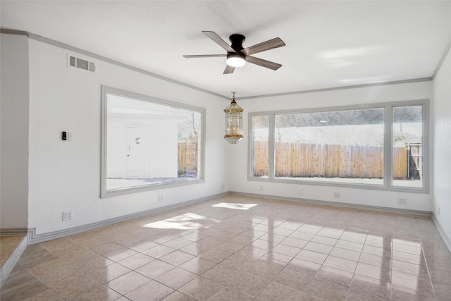 unfurnished room featuring a healthy amount of sunlight, visible vents, and baseboards