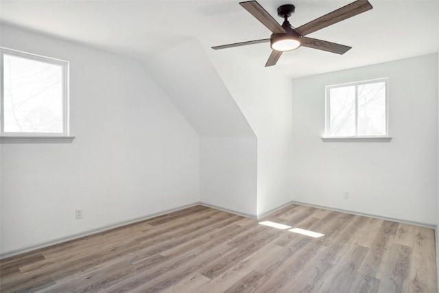 additional living space with lofted ceiling, ceiling fan, and wood finished floors