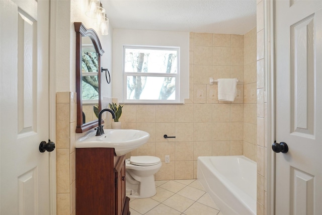 full bath featuring toilet, tile patterned flooring, a washtub, vanity, and tile walls