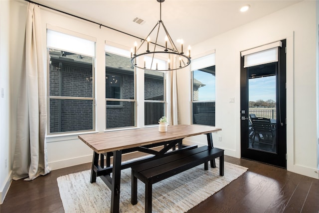 dining room featuring dark wood-style floors, visible vents, and baseboards