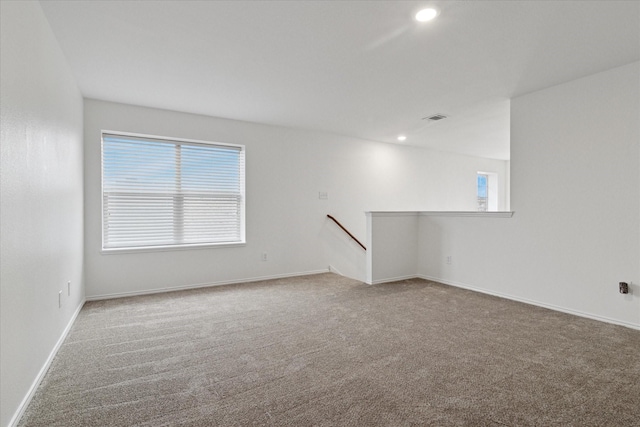 unfurnished room with visible vents, recessed lighting, baseboards, and carpet floors