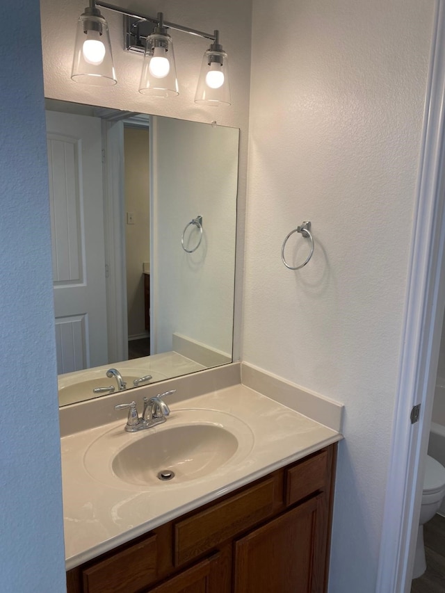 bathroom featuring vanity and toilet