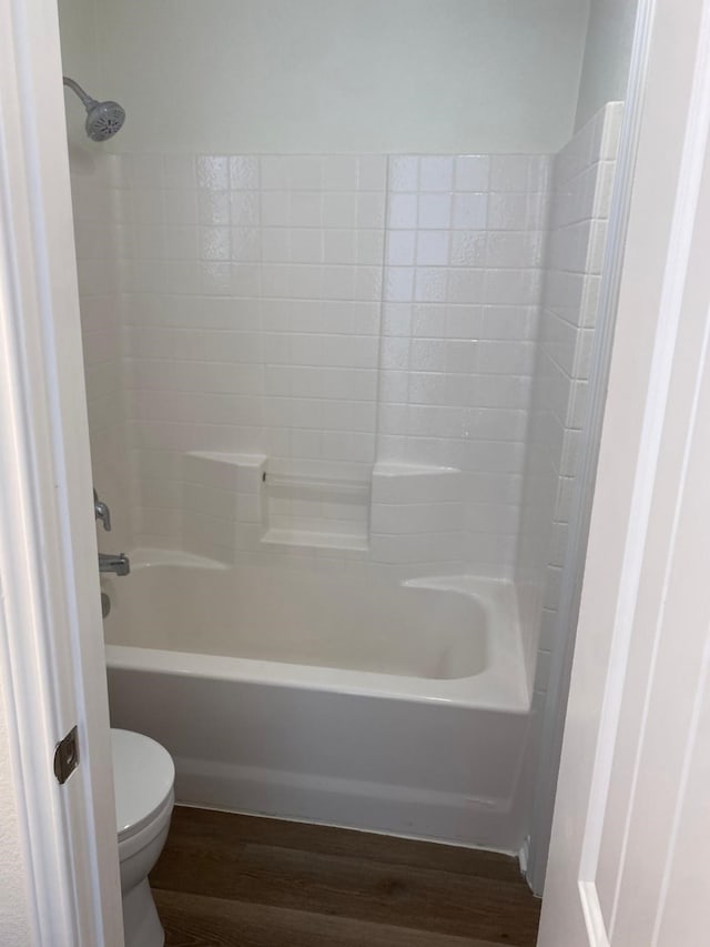 full bath featuring toilet, shower / tub combination, and wood finished floors