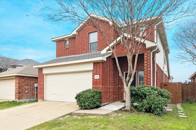 view of front of property with brick siding, driveway, an attached garage, and fence