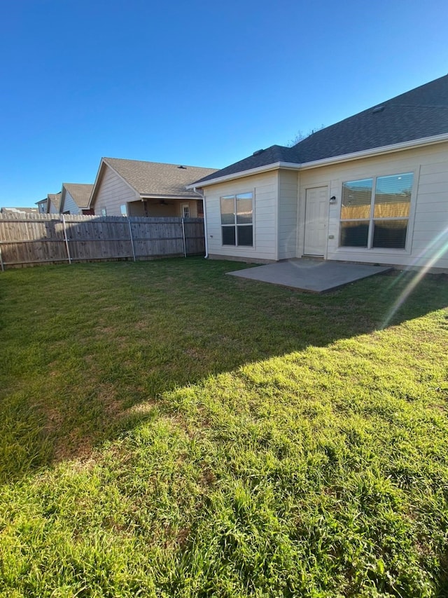 back of property featuring a patio area, fence, and a lawn