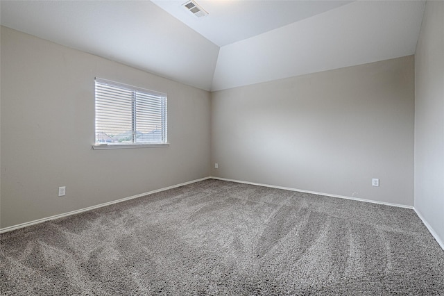 unfurnished room with lofted ceiling, carpet, visible vents, and baseboards