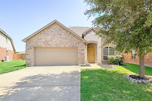 french country home featuring a garage, concrete driveway, brick siding, and a front lawn