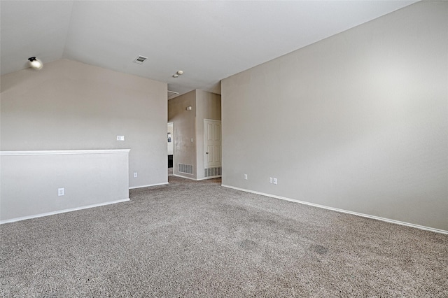 carpeted empty room with lofted ceiling, visible vents, and baseboards