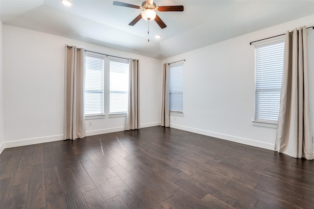 unfurnished room featuring dark wood finished floors, baseboards, and ceiling fan