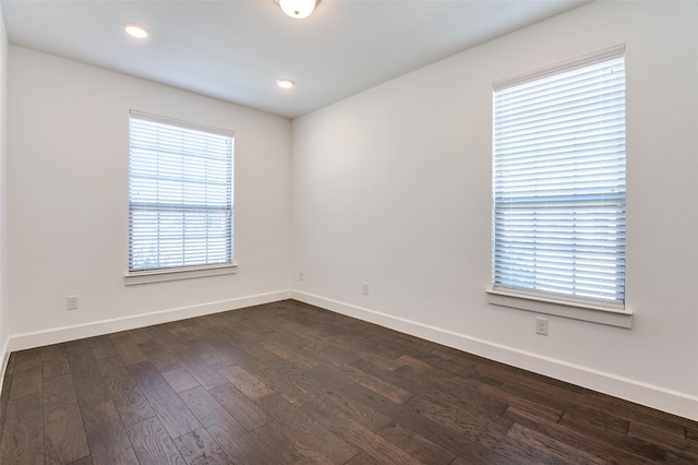 unfurnished room featuring baseboards, dark wood-type flooring, and recessed lighting