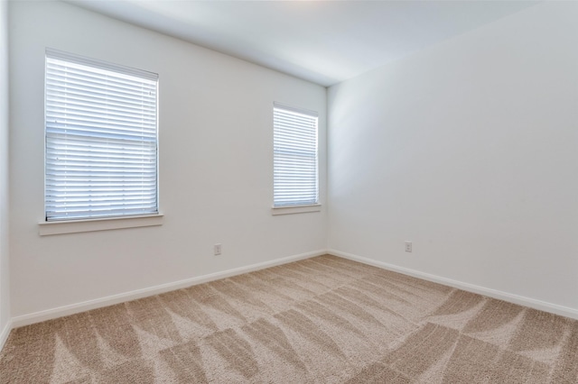 empty room with carpet and baseboards