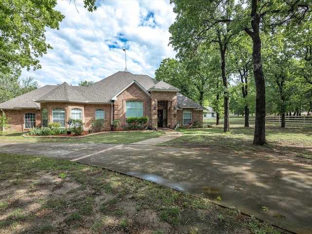 102 W Ridge St, Decatur, TX 76234 - view of front facade featuring brick siding, a shingled roof, a front lawn, and fence