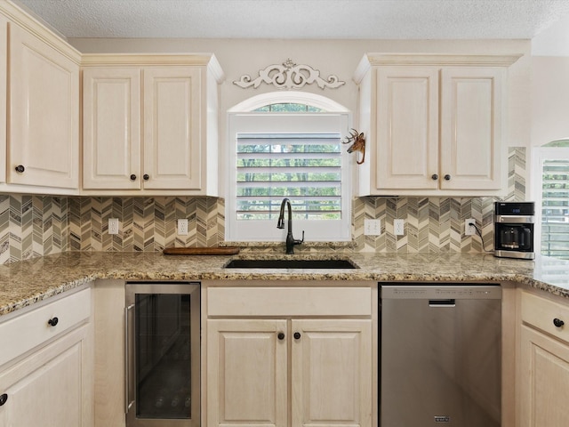 kitchen featuring decorative backsplash, beverage cooler, dishwasher, and a sink