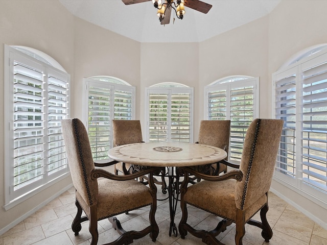 dining area with ceiling fan, light tile patterned flooring, and baseboards