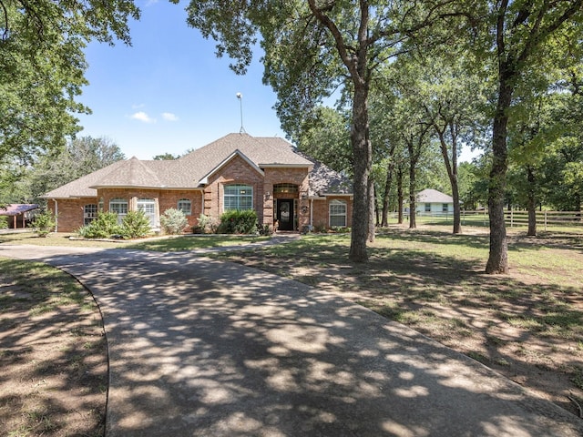 ranch-style house with brick siding and fence