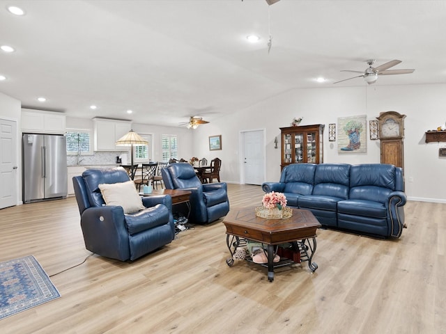 living area with vaulted ceiling, light wood-type flooring, a ceiling fan, and recessed lighting