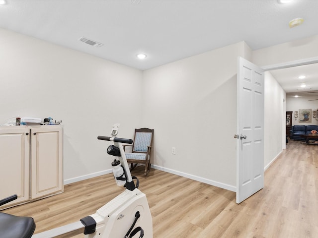 exercise room with baseboards, recessed lighting, visible vents, and light wood-style floors