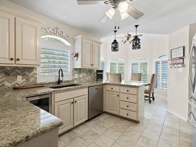 kitchen with beverage cooler, dishwasher, backsplash, a peninsula, and a sink