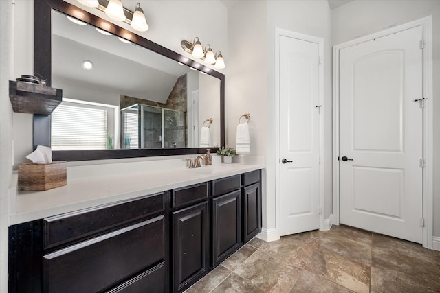 bathroom with a shower stall, vanity, and baseboards