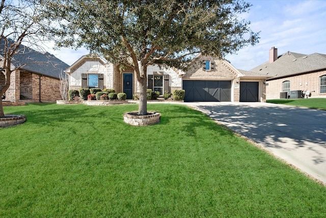 french provincial home featuring a garage, driveway, stone siding, a front yard, and brick siding