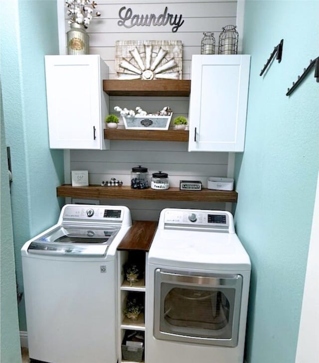 washroom with cabinet space and independent washer and dryer