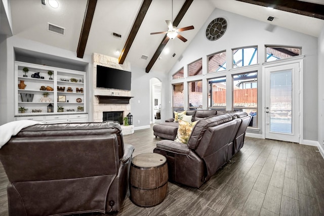 living room with dark wood-style floors, a fireplace, visible vents, a ceiling fan, and high vaulted ceiling